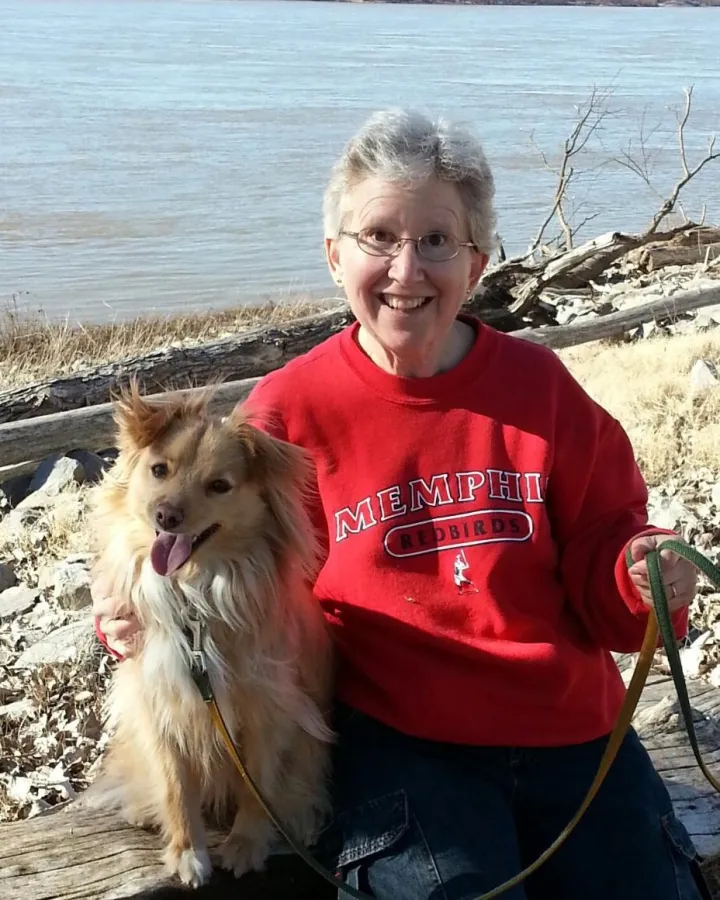 Tink, a small, fluffy mixed breed dog, with her handler Kathy