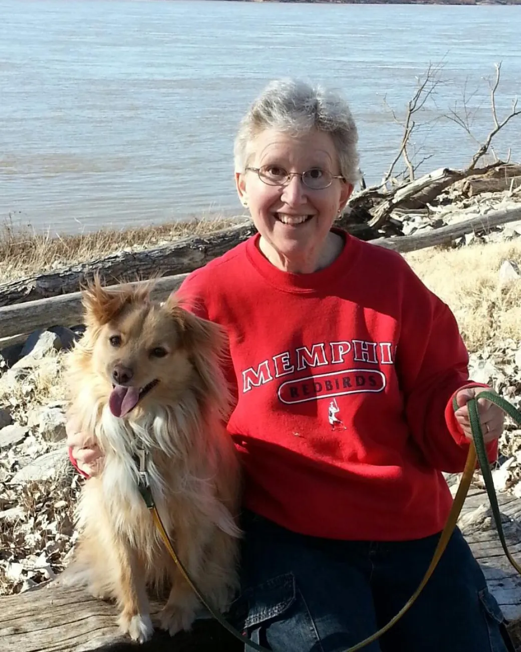 Tink, a small, fluffy mixed breed dog, with her handler Kathy